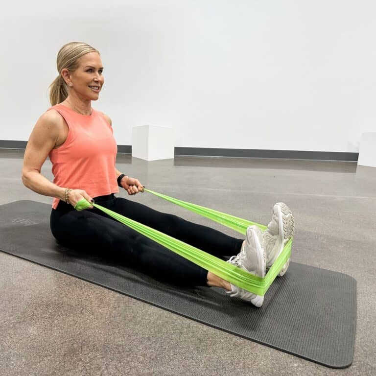 woman showing flexibility vs mobility using band in gym