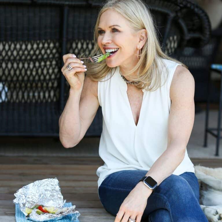 woman eating protein showing how she gets 30g at every meal