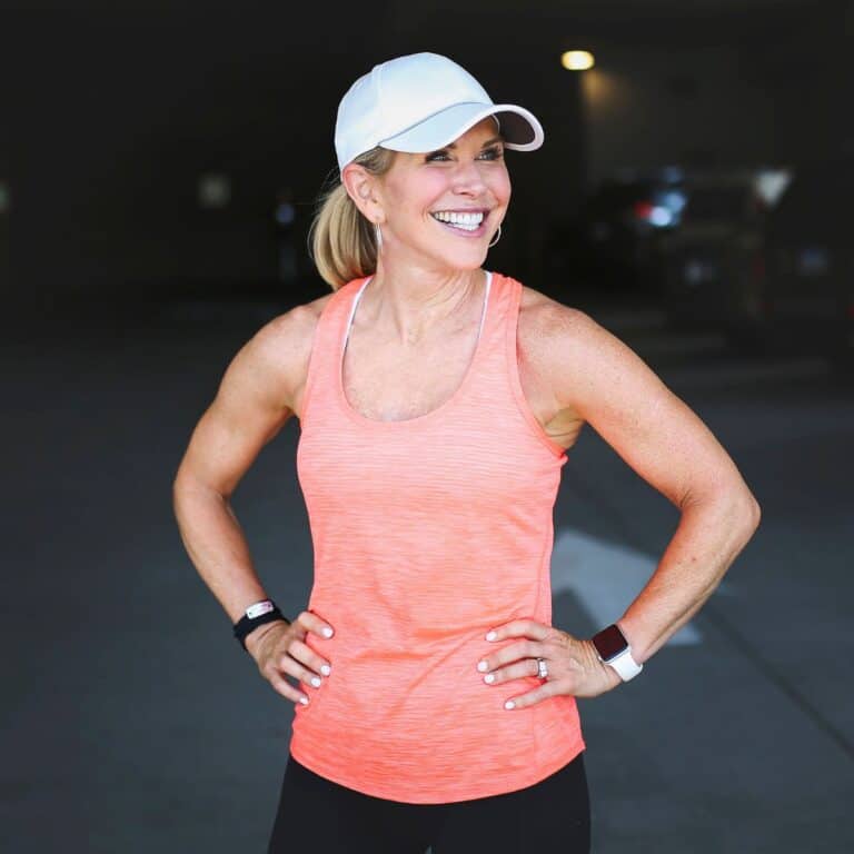 woman smiling standing in workout top