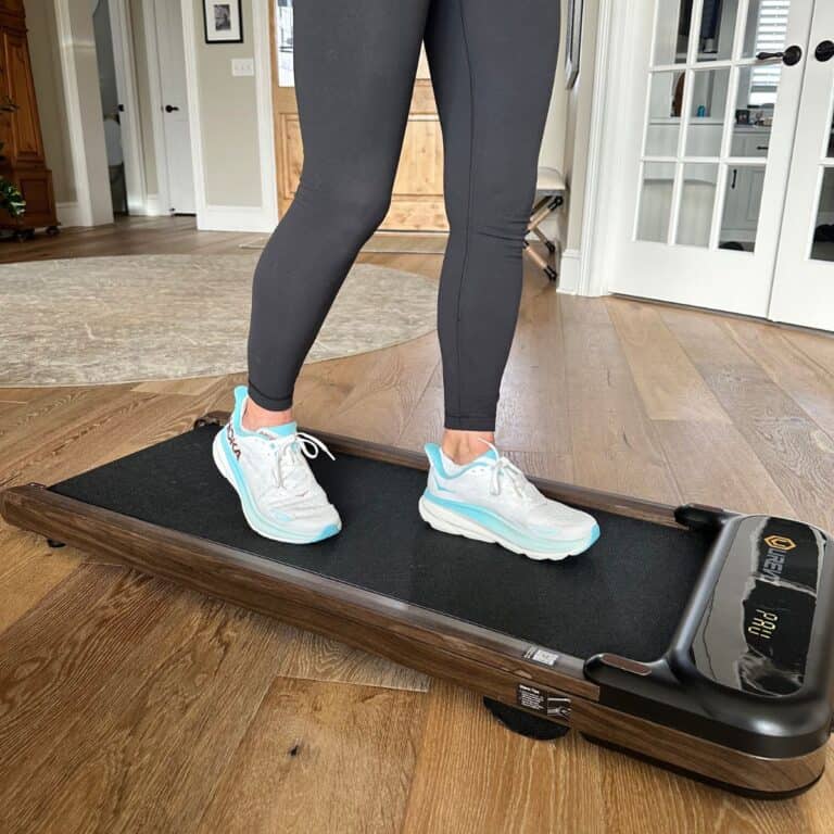 personal trainer walking on walking pad in living room