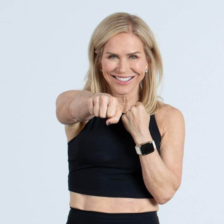 woman smiling air punching sharing tips for staying consistent with exercise