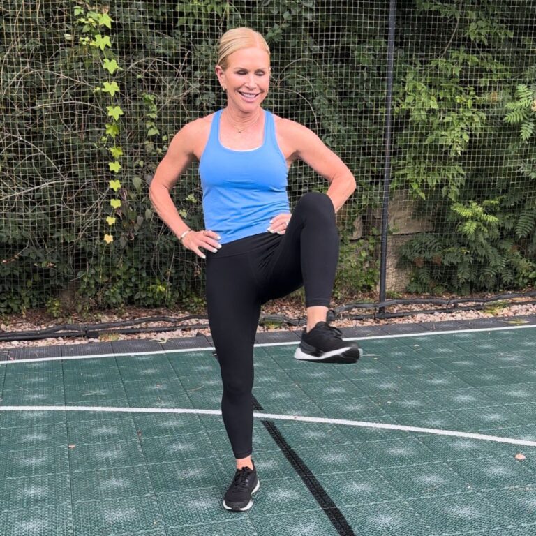 Woman exercising with high knee lift outdoors.